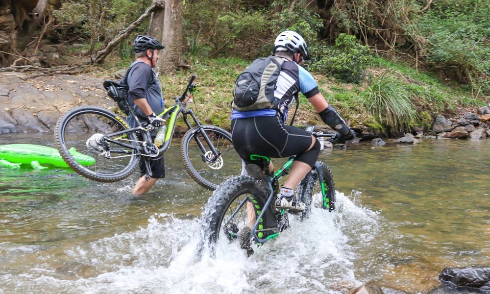 Scott Big Jon fat bike charges through a rainforest river crossing